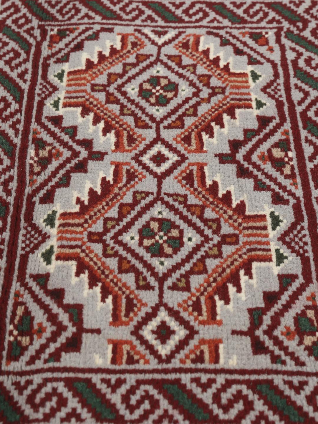 Hand-knotted Middle Eastern Baluch rug in red and grey wool