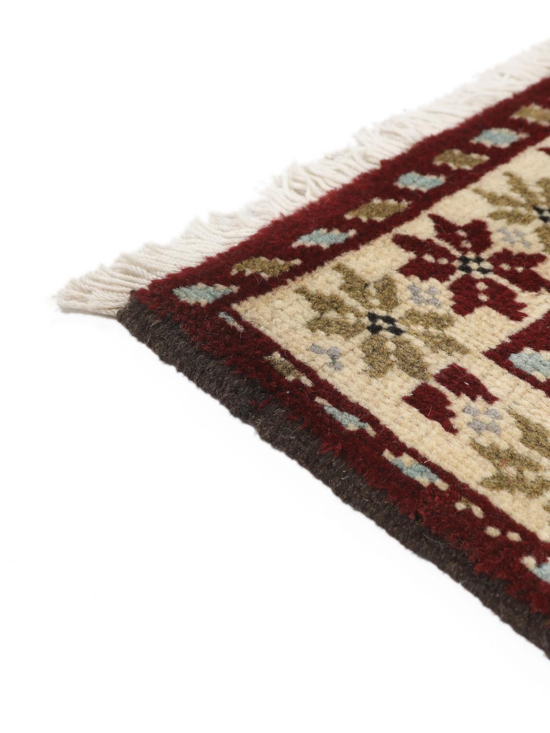 Hand-knotted Beluch rug with geometric motifs in red, blue, and cream