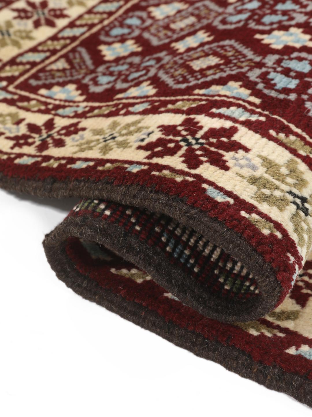 Hand-knotted Beluch rug with geometric motifs in red, blue, and cream