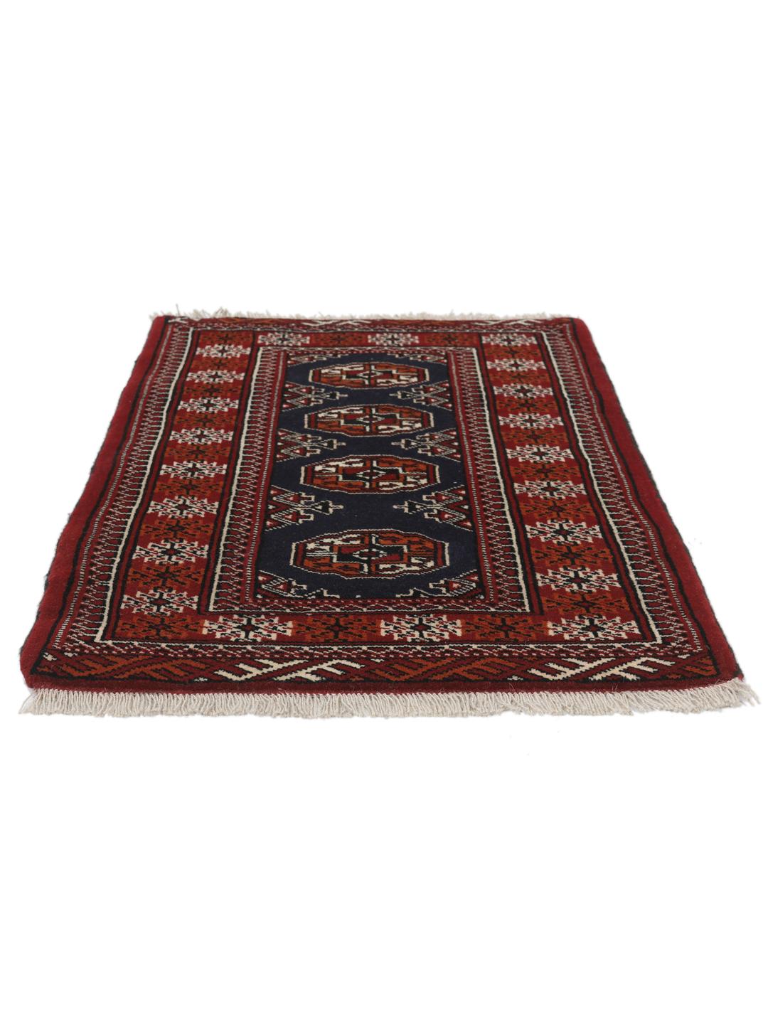 Hand-knotted Turkaman rug from the Middle East in dark-red and dark-blue tones.