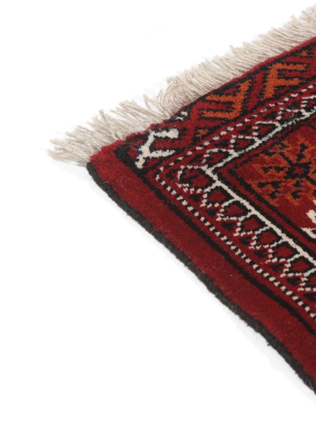 Hand-knotted Turkaman rug from the Middle East in dark-red and dark-blue tones.