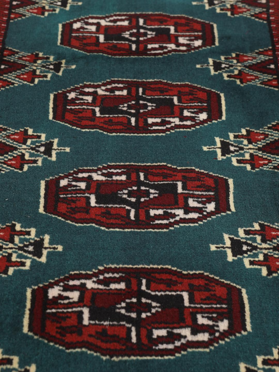 Hand-knotted Turkaman rug from the Middle East in dark-red and dark-teal