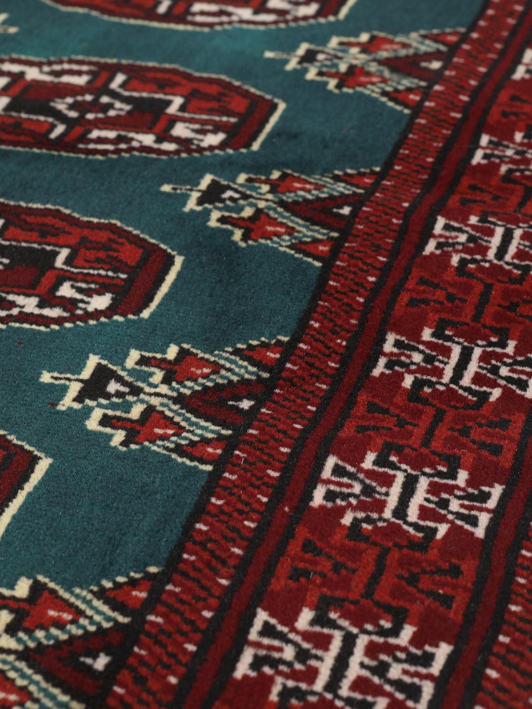 Hand-knotted Turkaman rug from the Middle East in dark-red and dark-teal