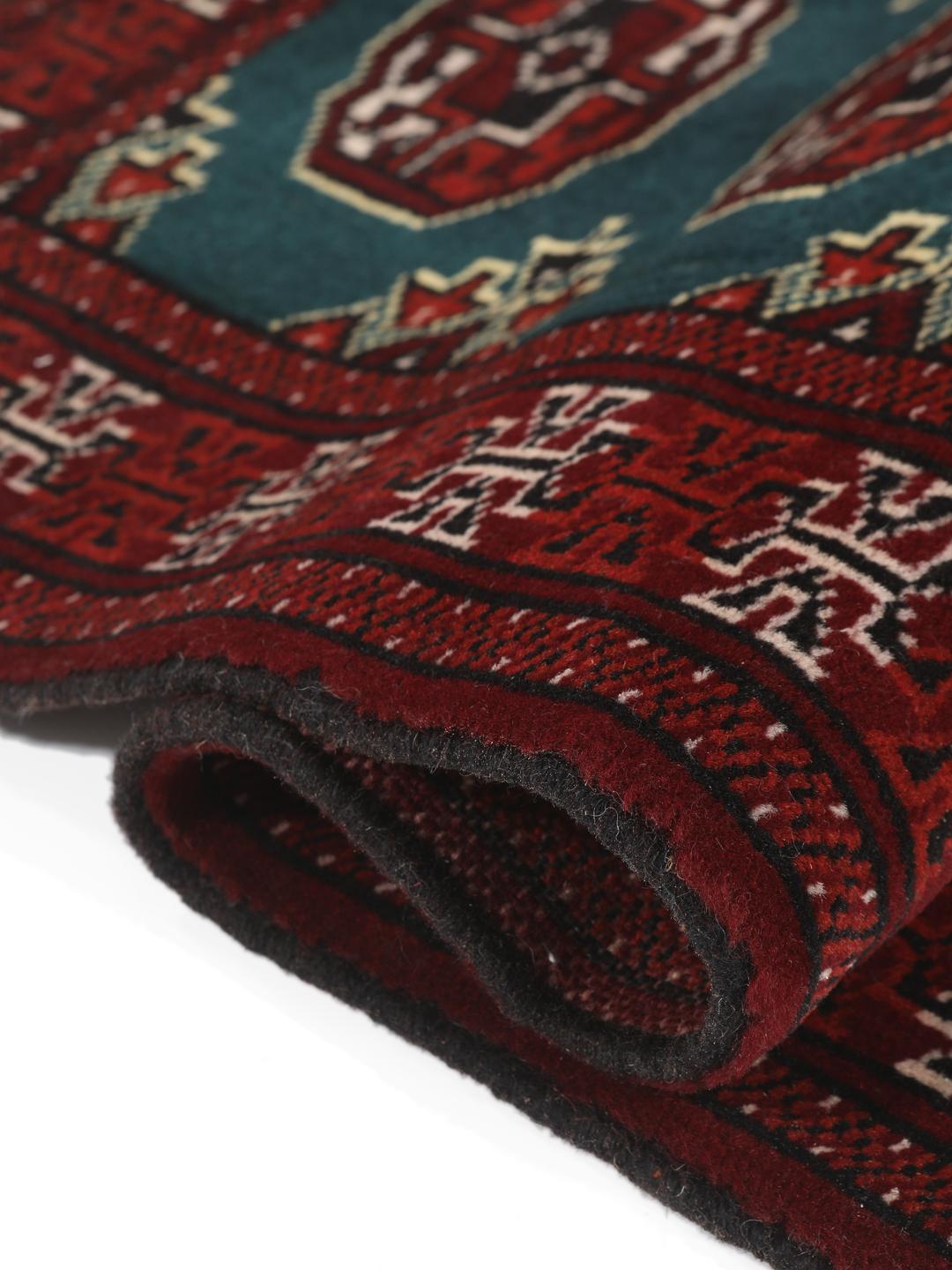 Hand-knotted Turkaman rug from the Middle East in dark-red and dark-teal