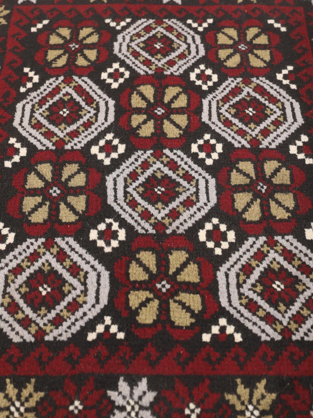 Hand-knotted Baluch rug with geometric patterns in dark-red and dark-grey