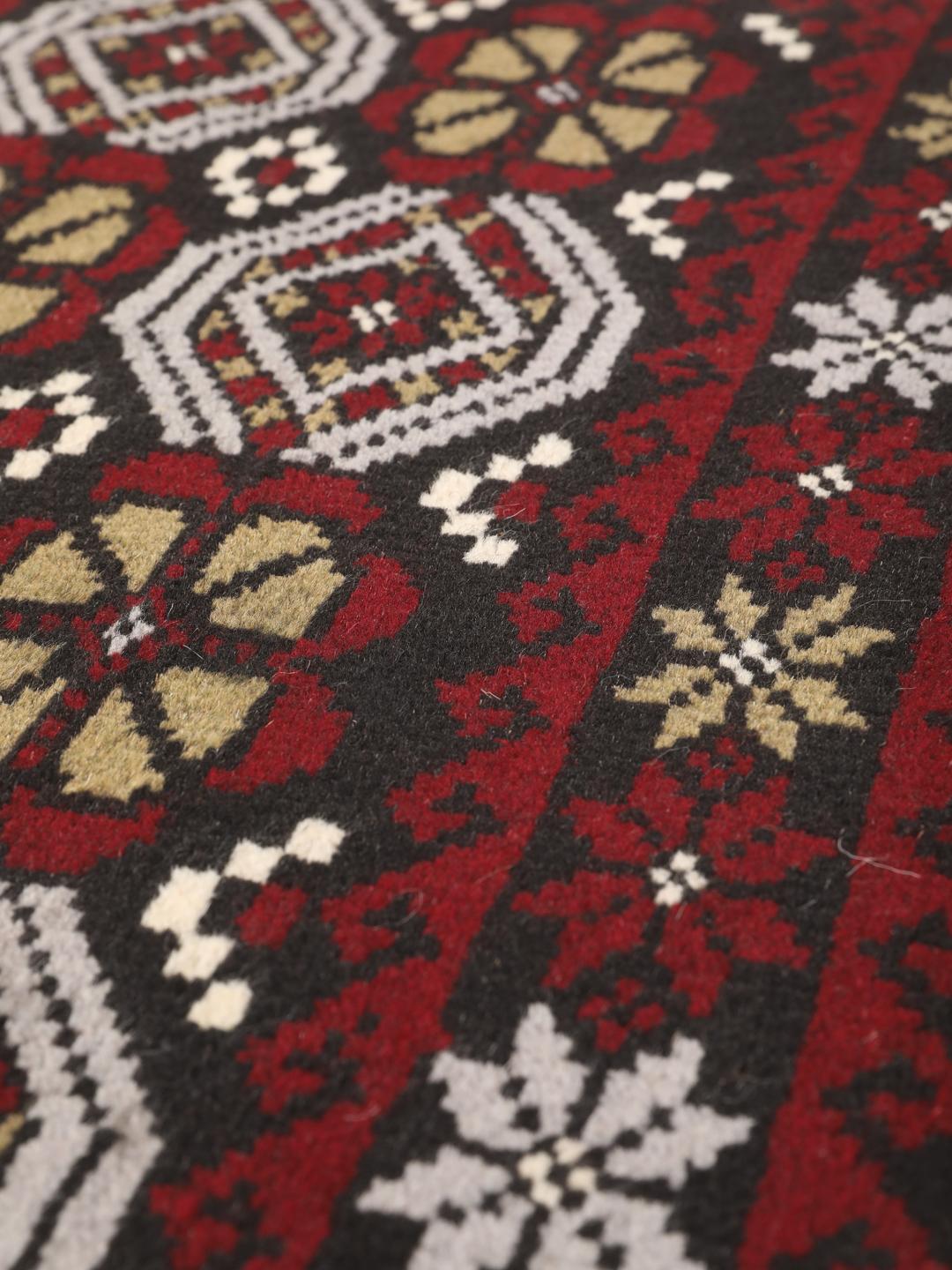 Hand-knotted Baluch rug with geometric patterns in dark-red and dark-grey