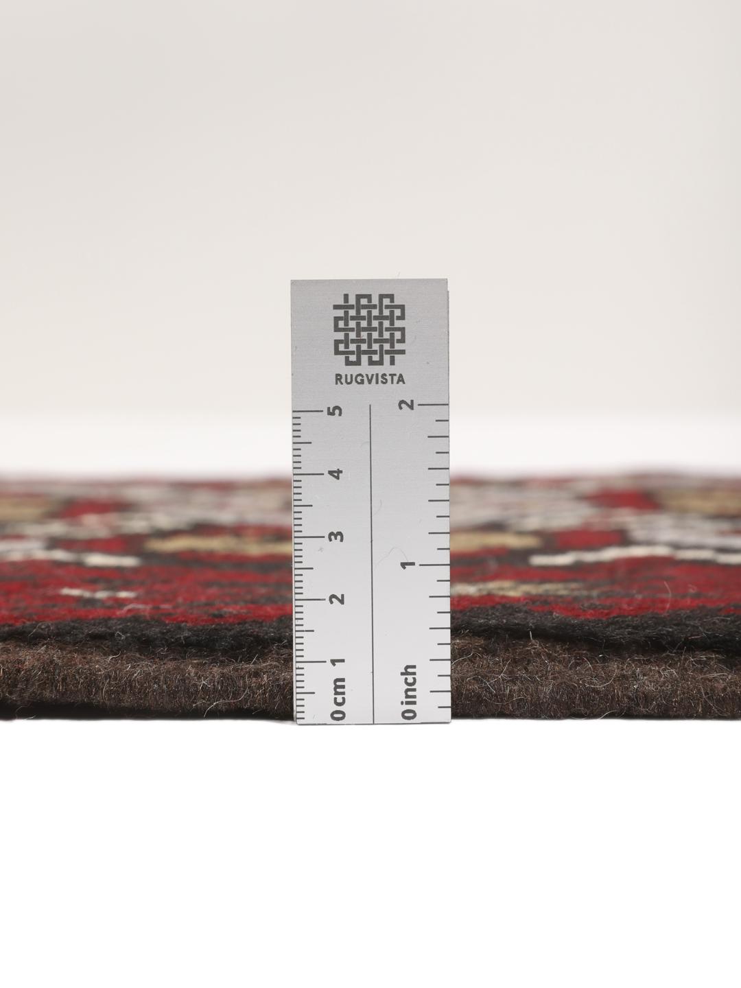 Hand-knotted Baluch rug with geometric patterns in dark-red and dark-grey