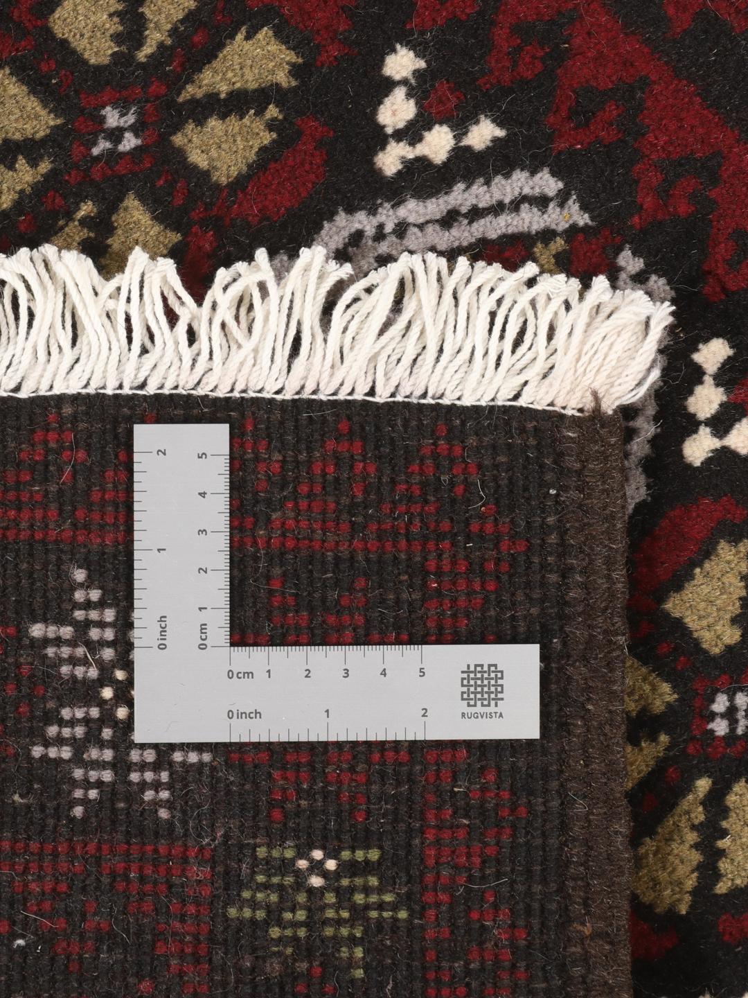 Hand-knotted Baluch rug with geometric patterns in dark-red and dark-grey