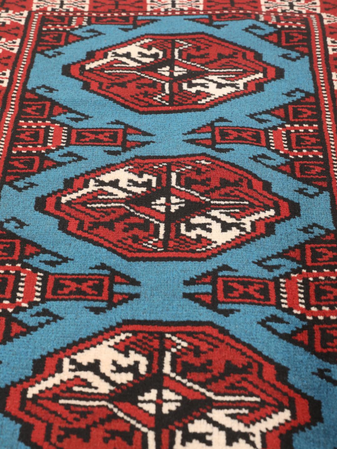 Hand-knotted Turkaman rug from the Middle East in red and blue tones