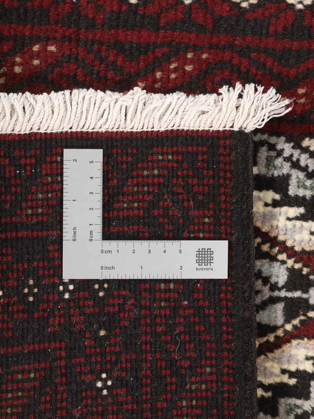 Ein handgeknüpfter Beluch-Teppich mit dunkelrotem und schwarzem Feld aus dem Nahen Osten.