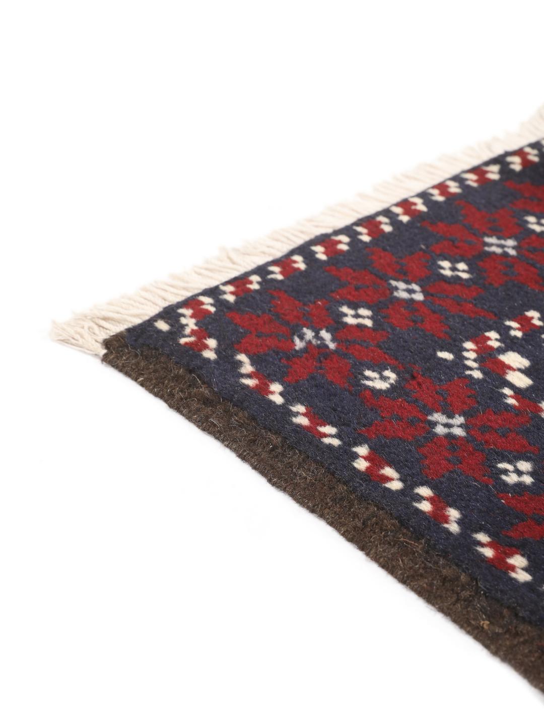 Hand-knotted Baluch rug with geometric motifs in dark-blue and red from the Middle East