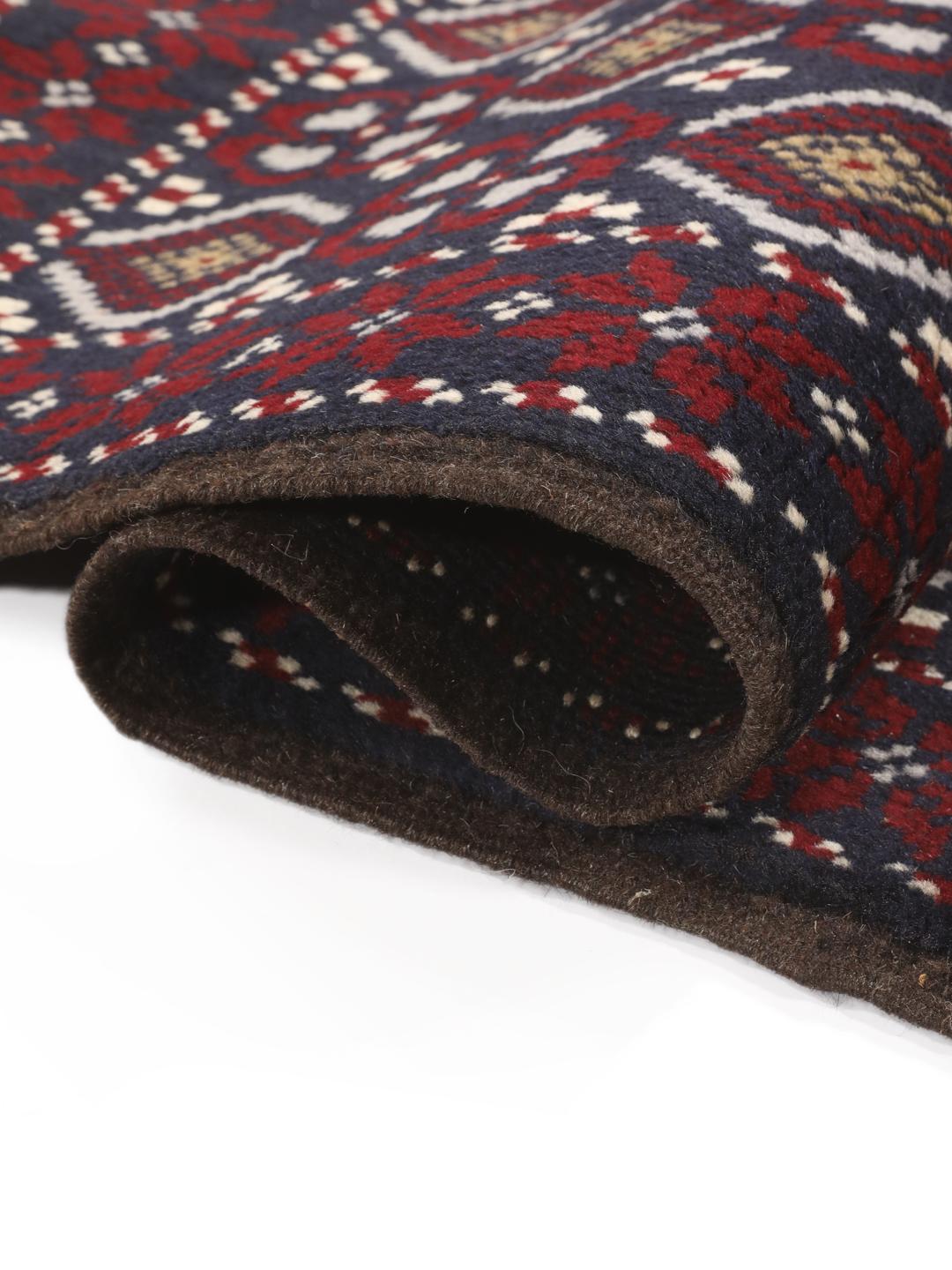 Hand-knotted Baluch rug with geometric motifs in dark-blue and red from the Middle East