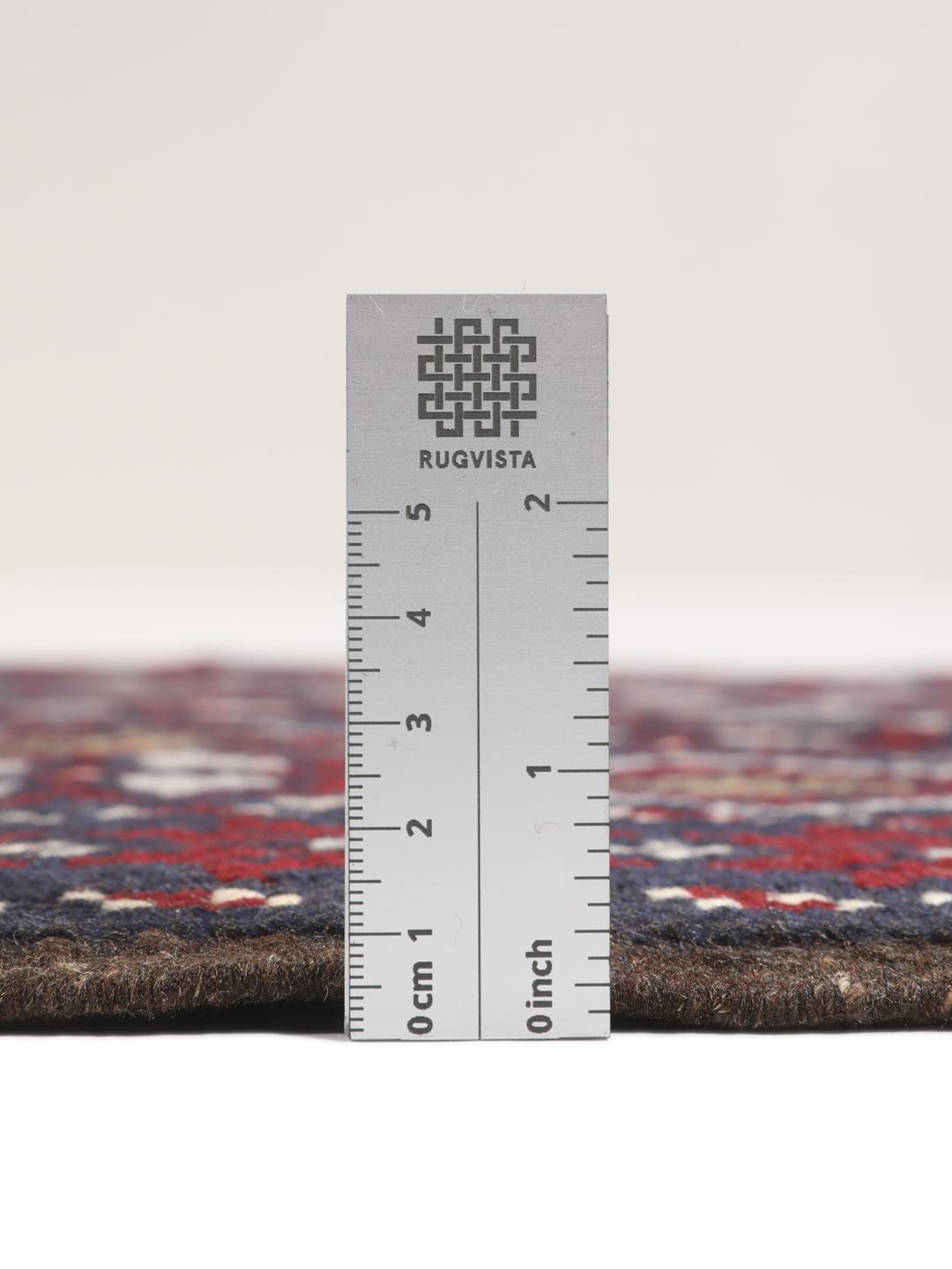 Hand-knotted Baluch rug with geometric motifs in dark-blue and red from the Middle East