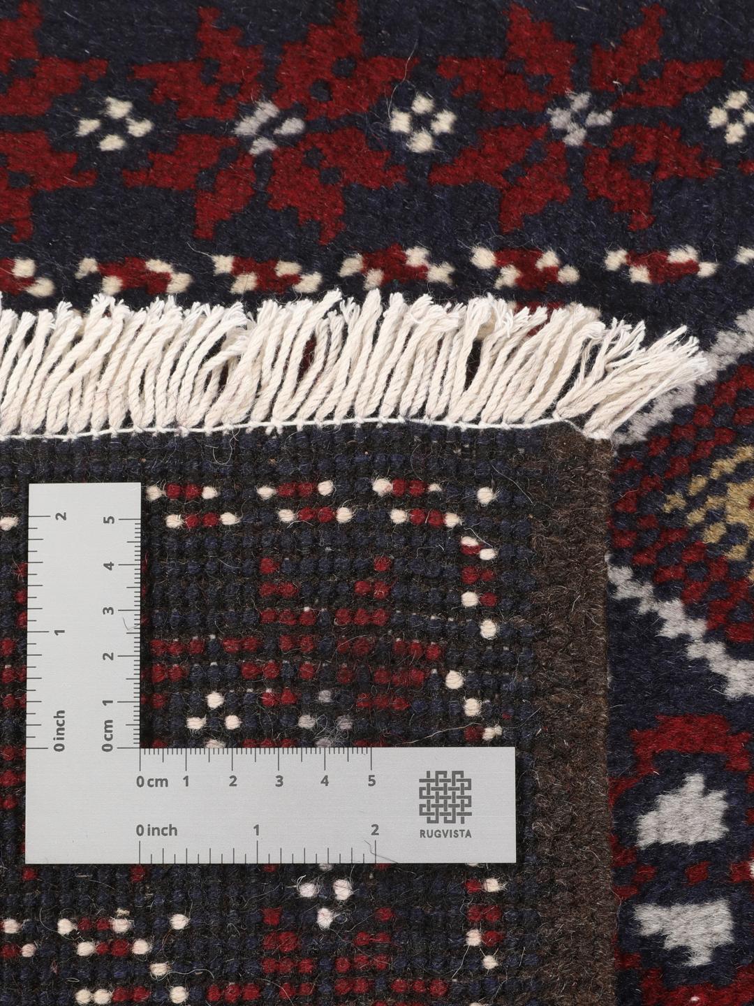 Hand-knotted Baluch rug with geometric motifs in dark-blue and red from the Middle East