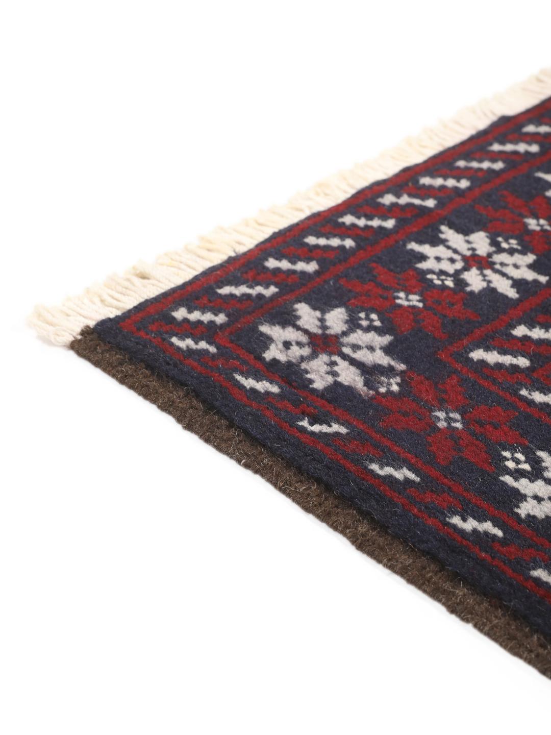 Hand-knotted Baluch rug with geometric tribal patterns in dark blue and red