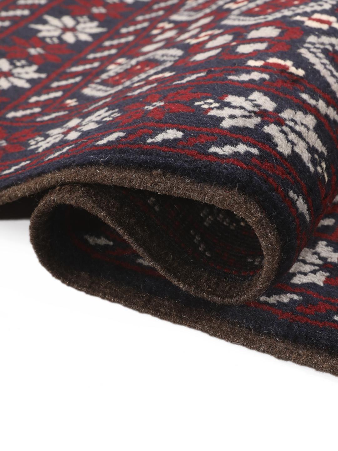 Hand-knotted Baluch rug with geometric tribal patterns in dark blue and red