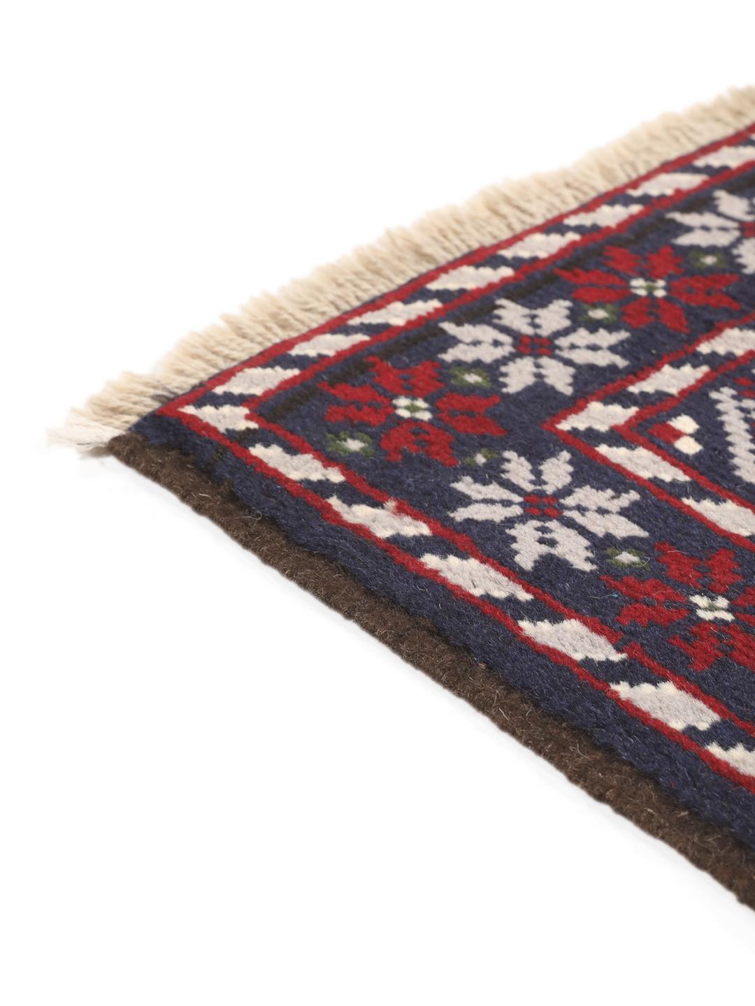 Handmade Baluch rug from the Middle East in dark-blue and dark-red tones.