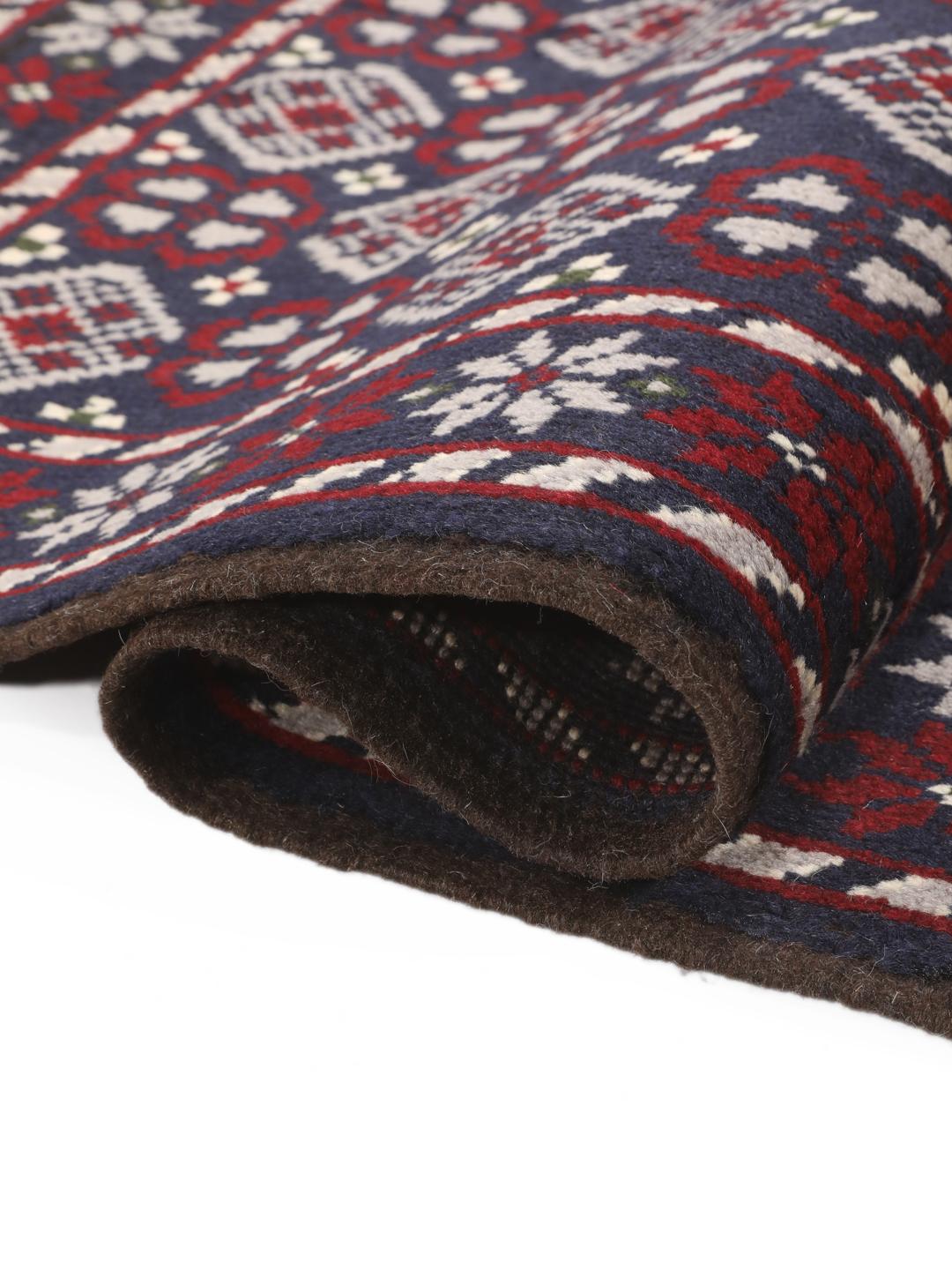 Handmade Baluch rug from the Middle East in dark-blue and dark-red tones.