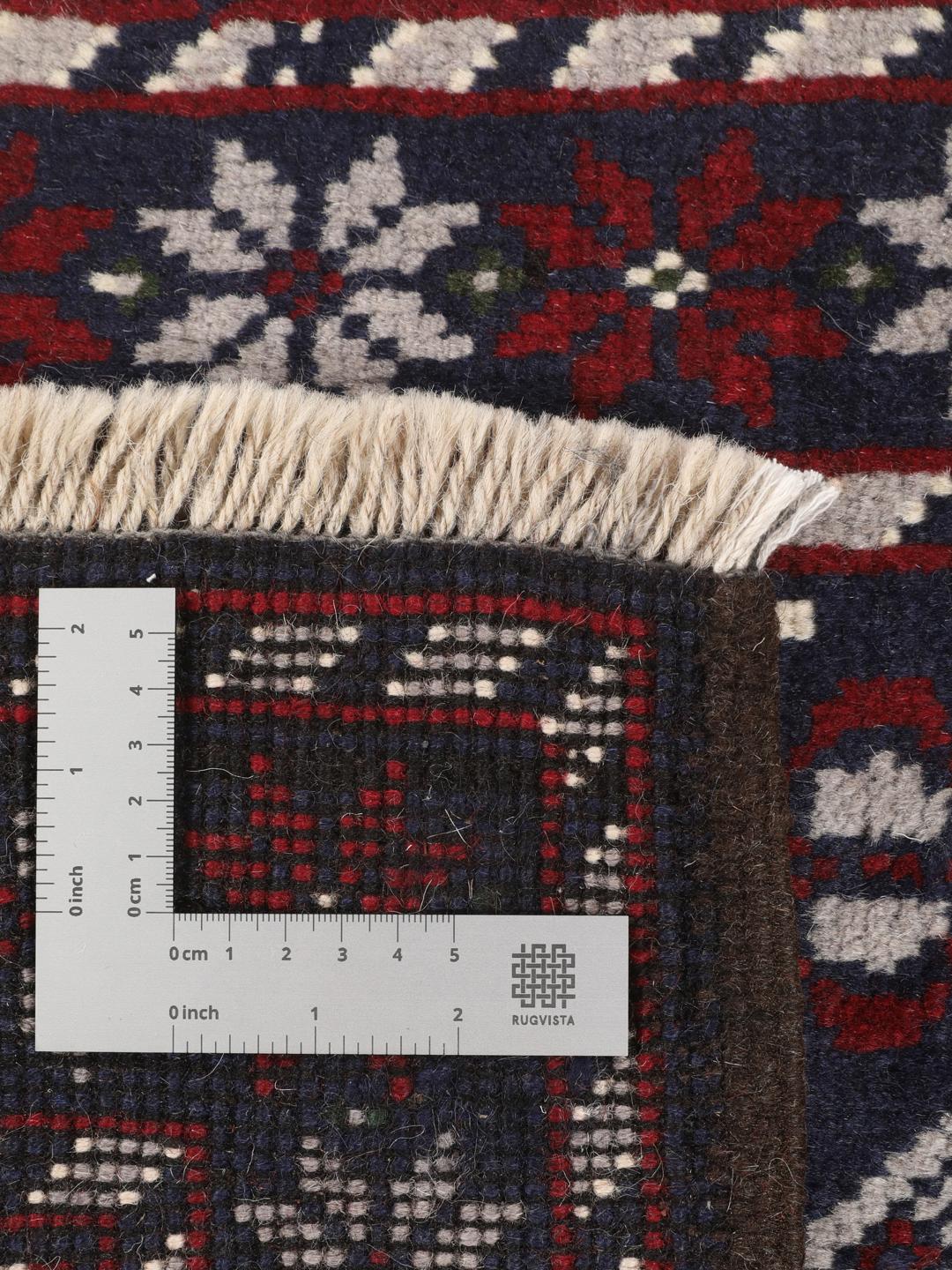Handmade Baluch rug from the Middle East in dark-blue and dark-red tones.
