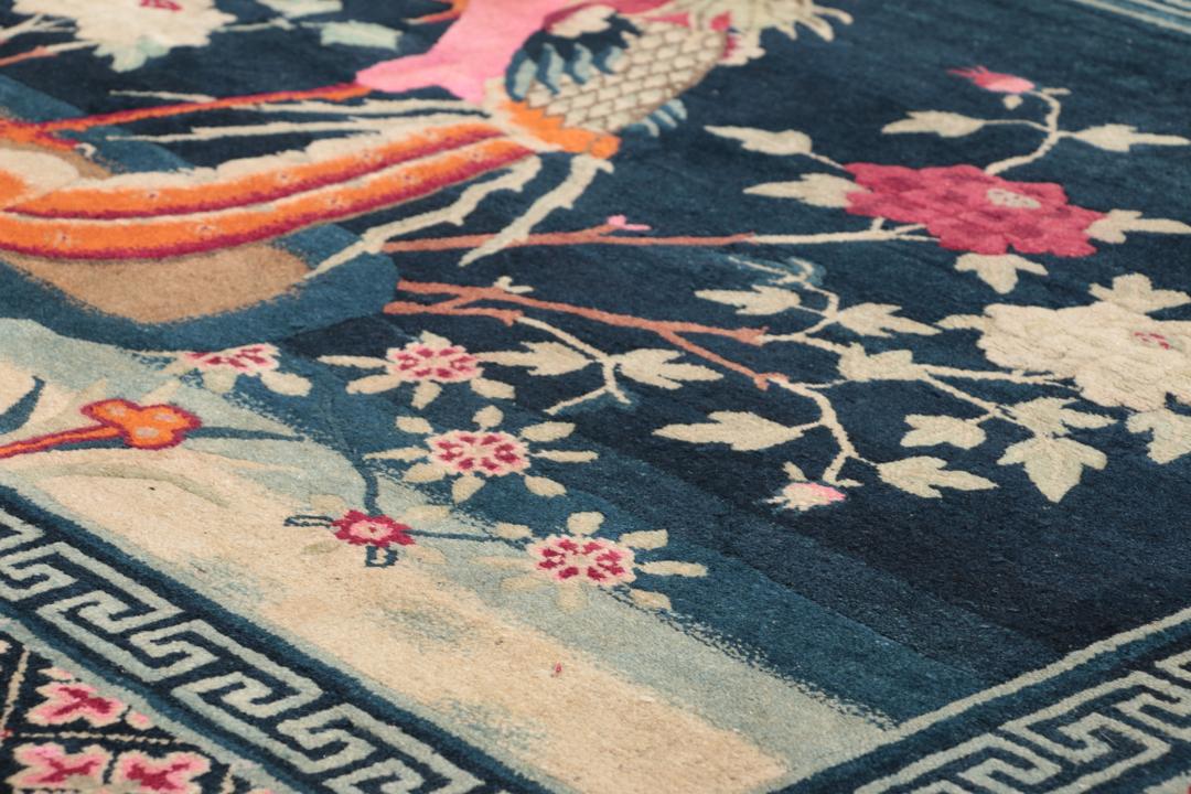 Antique Chinese Art Deco rug featuring a phoenix motif in dark-blue and pink