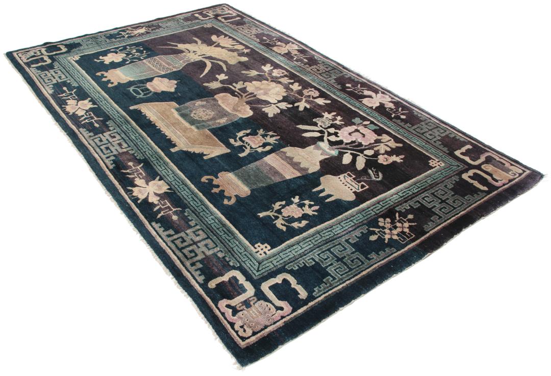Antique Chinese hand-knotted rug in deep blue and black with floral motifs