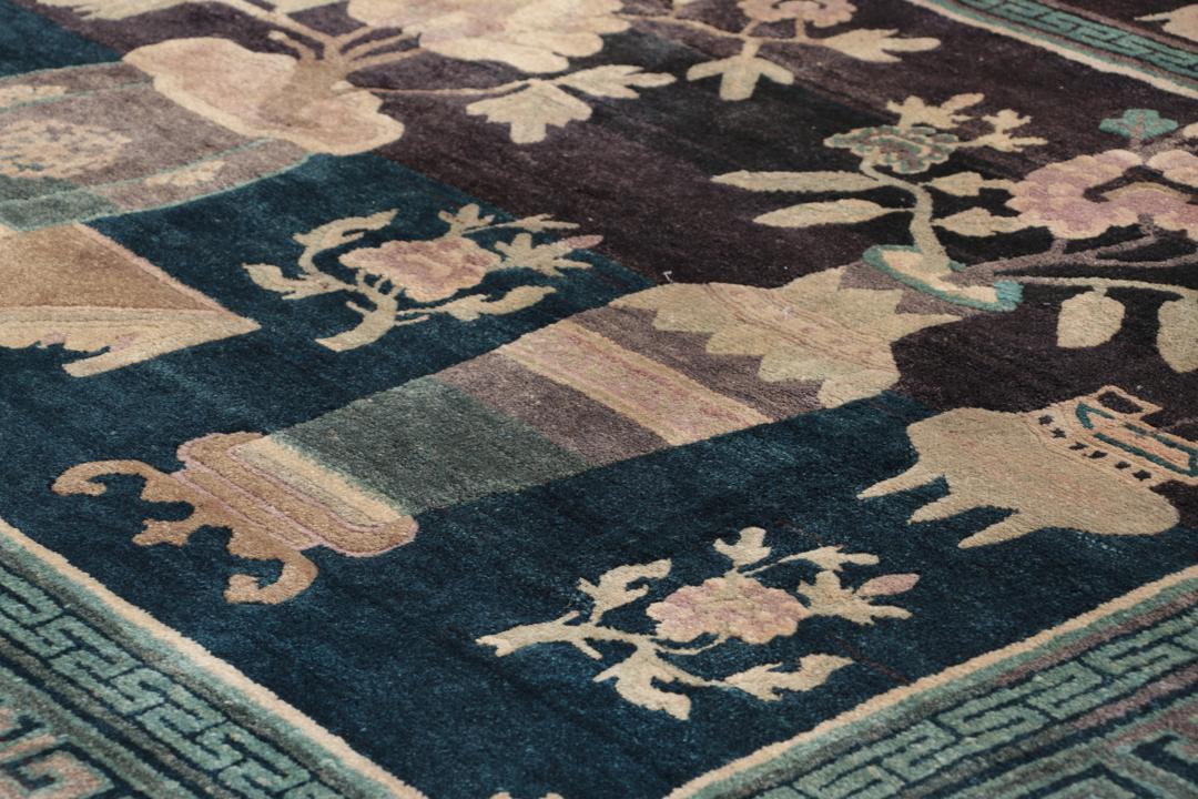 Antique Chinese hand-knotted rug in deep blue and black with floral motifs