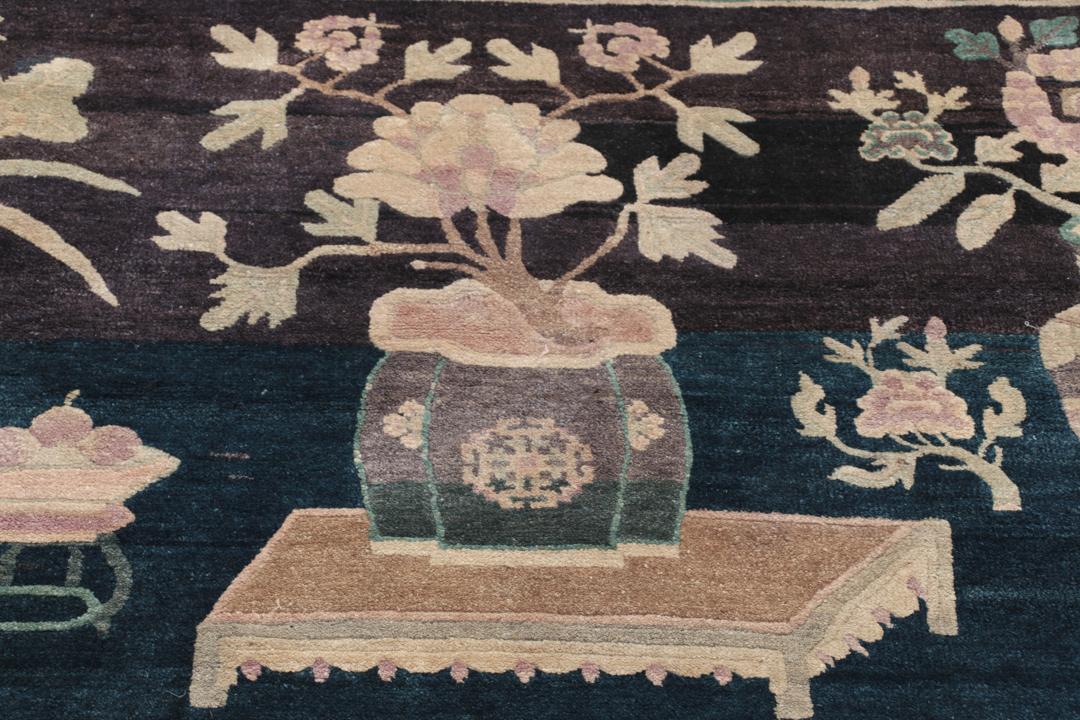 Antique Chinese hand-knotted rug in deep blue and black with floral motifs