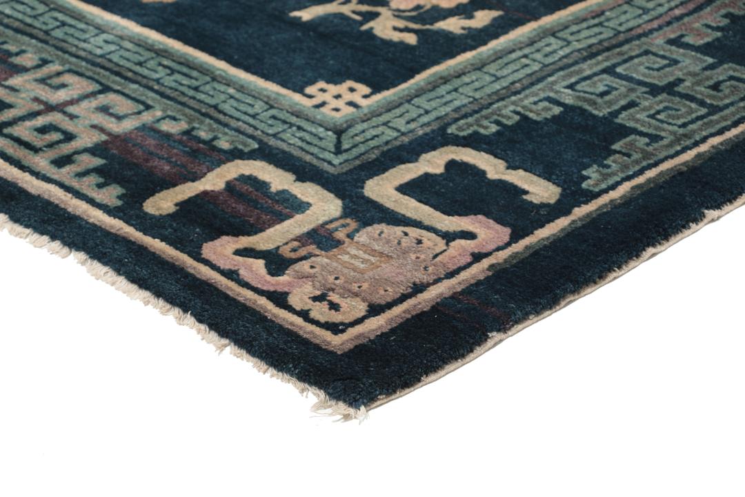 Antique Chinese hand-knotted rug in deep blue and black with floral motifs