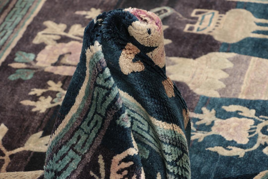 Antique Chinese hand-knotted rug in deep blue and black with floral motifs