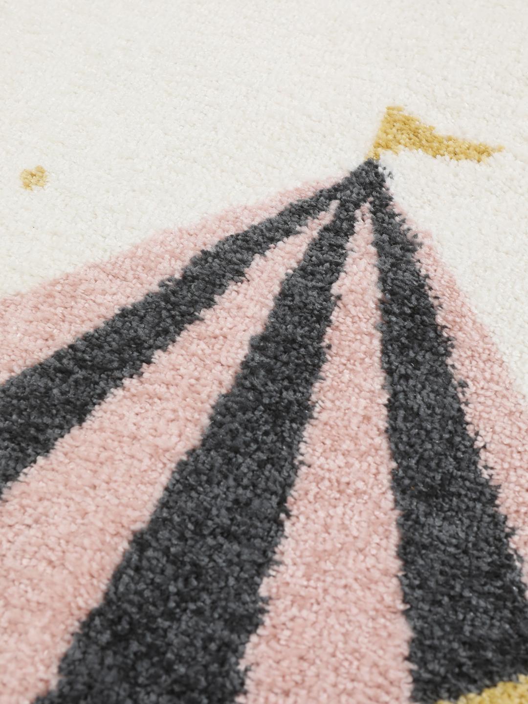 A playful circus-themed rug featuring a pink elephant and a monkey on an off-white background
