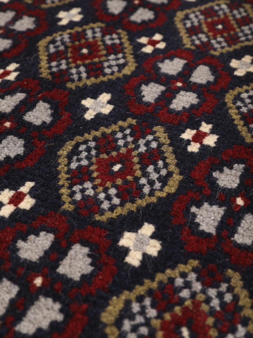 Ein handgeknüpfter Beluch-Teppich aus dem Nahen Osten mit einem tiefdunkelblauen und roten geometrischen Muster