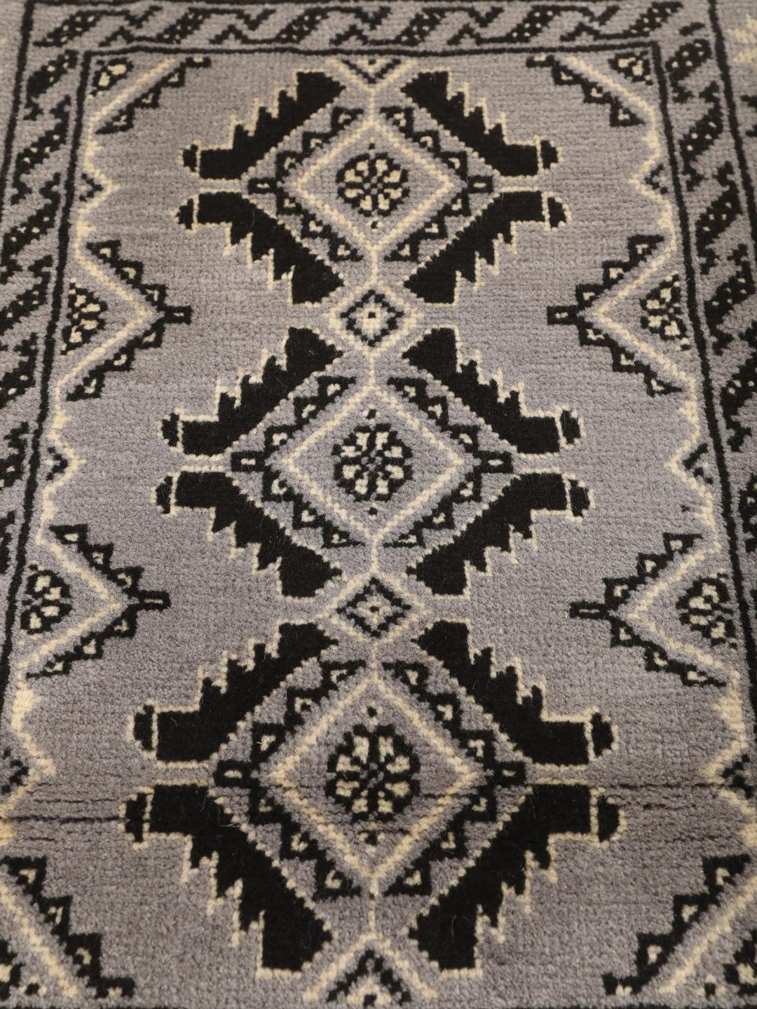 Hand-knotted Middle Eastern Baluch rug in grey and black with geometric patterns