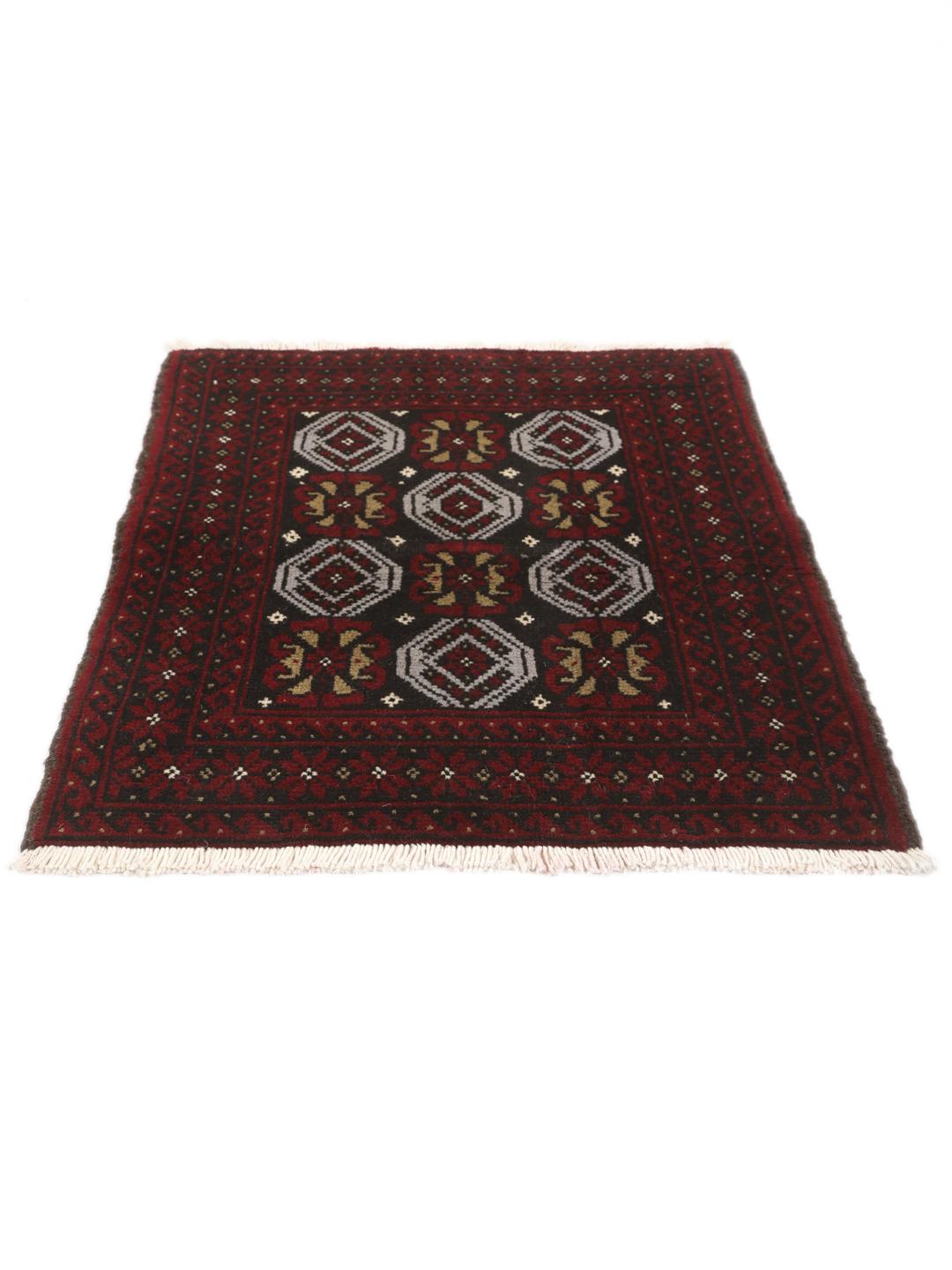 A small, one-of-a-kind Baluch rug from the Middle East with a dark-red and black geometric pattern.