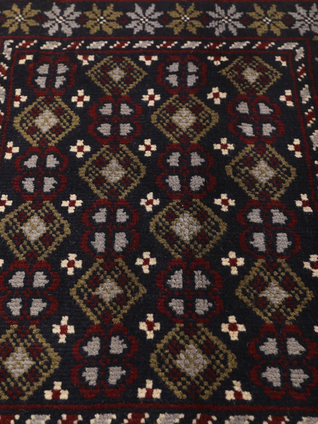 Hand-knotted Beluch rug with tribal motifs in dark-blue and red tones