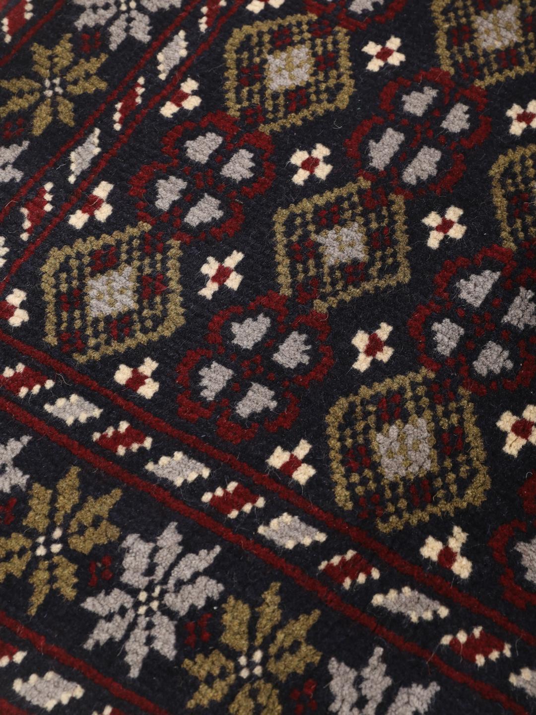 Hand-knotted Beluch rug with tribal motifs in dark-blue and red tones