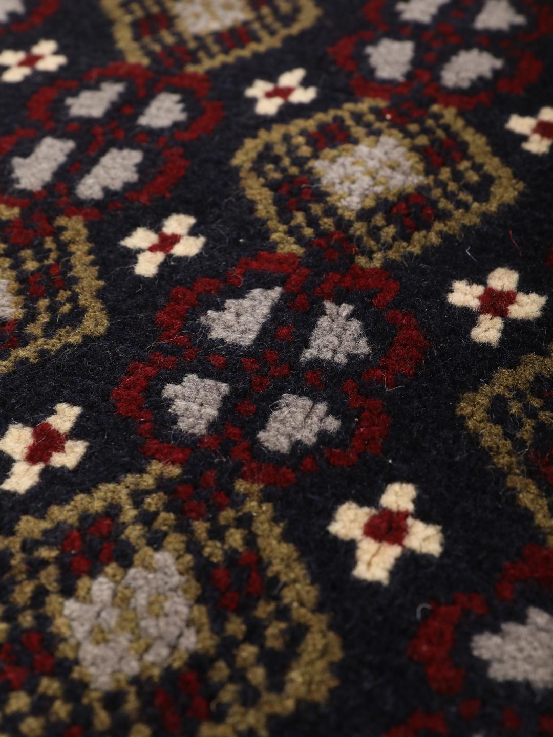 Hand-knotted Beluch rug with tribal motifs in dark-blue and red tones