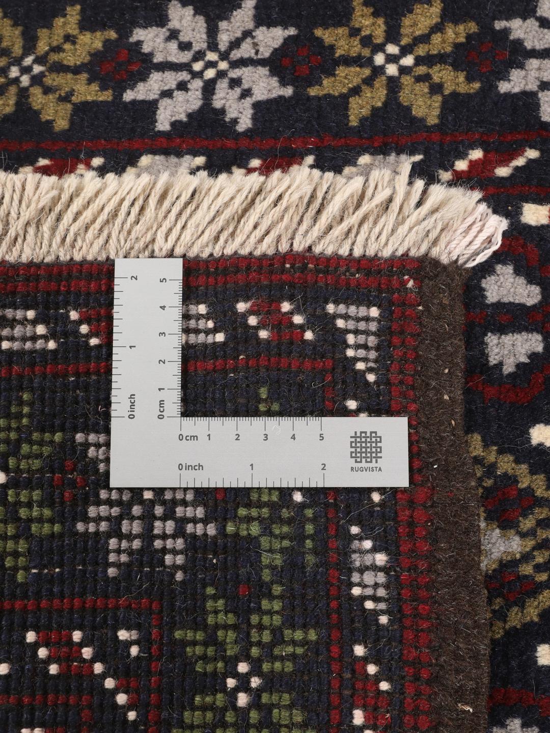 Hand-knotted Beluch rug with tribal motifs in dark-blue and red tones