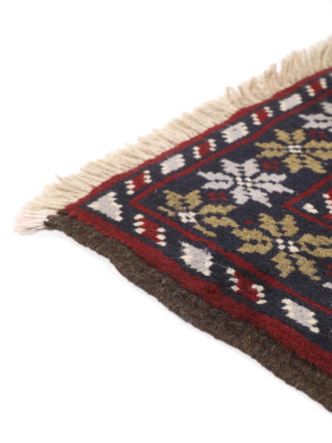 Hand-knotted Beluch rug with tribal motifs in dark-blue and red tones