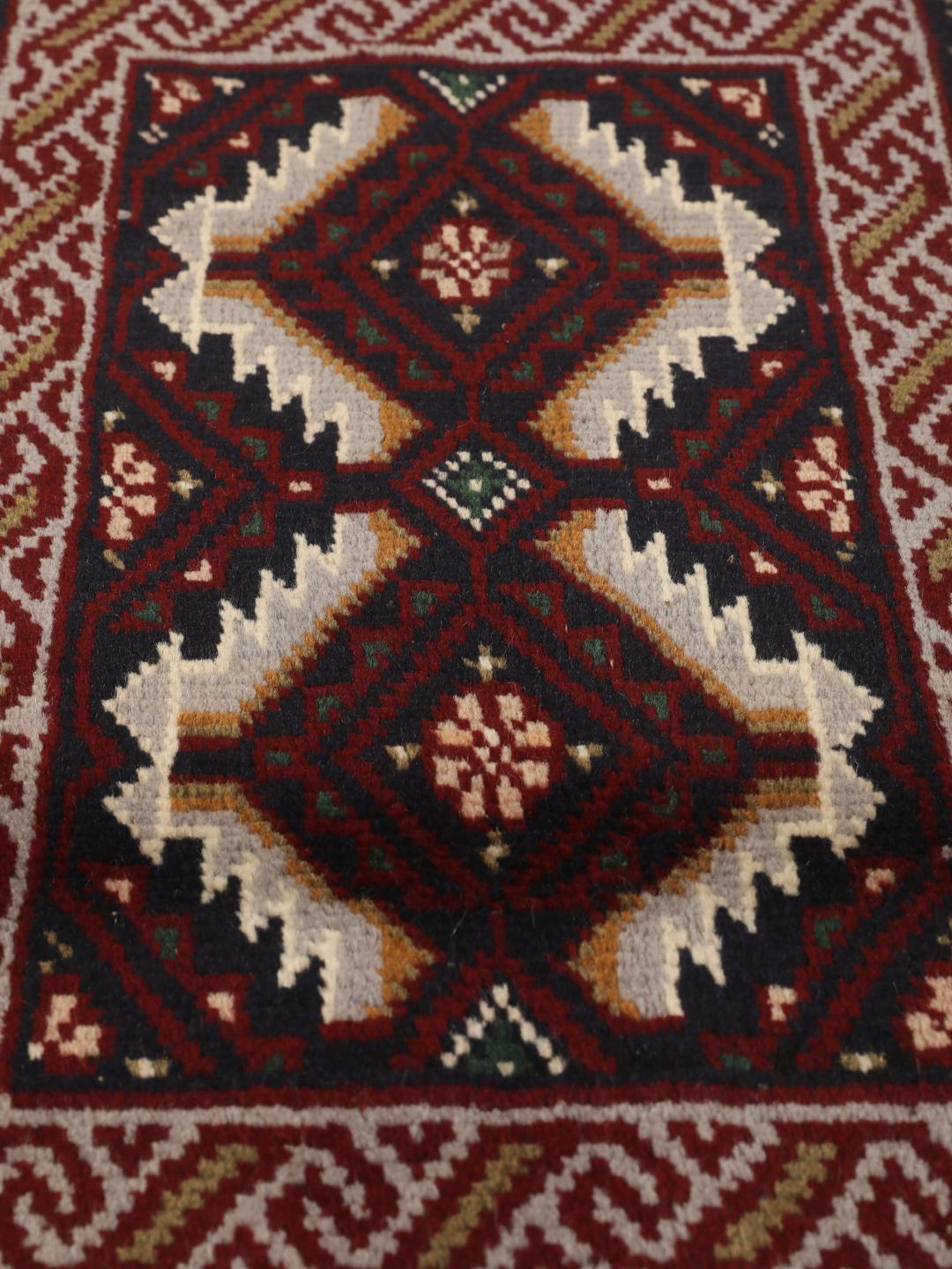 Hand-knotted Middle Eastern Baluch rug in dark-red and dark-blue Wool