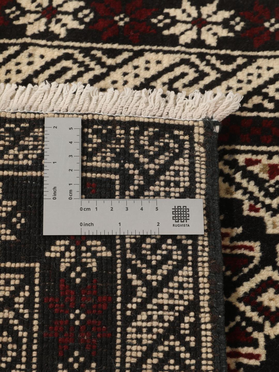 Håndknyttet Beluch-tæppe med geometriske motiver i mørkerødt og sort fra Mellemøsten.