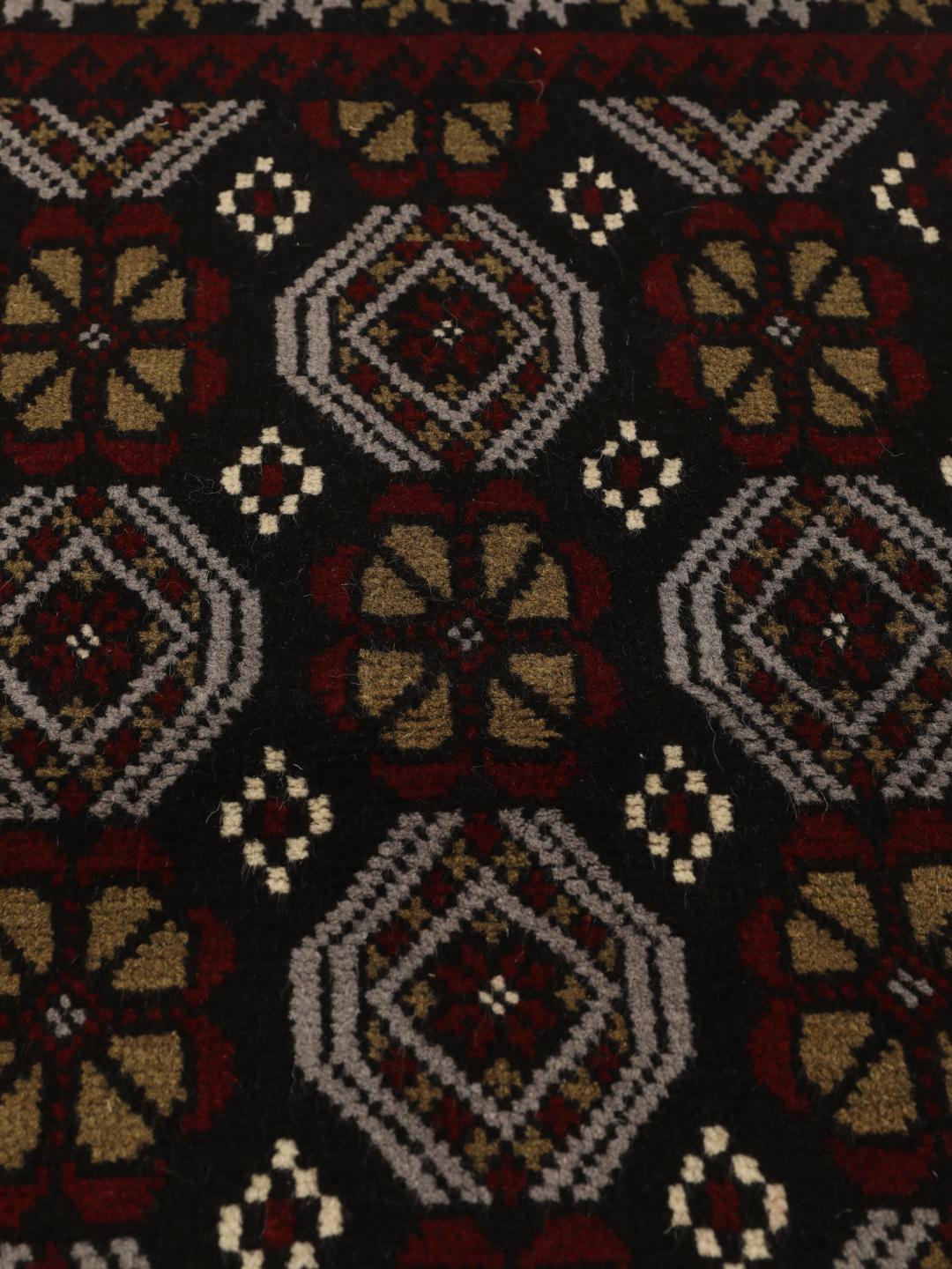 Handmade Middle Eastern Beluch rug with tribal motifs in multicolor