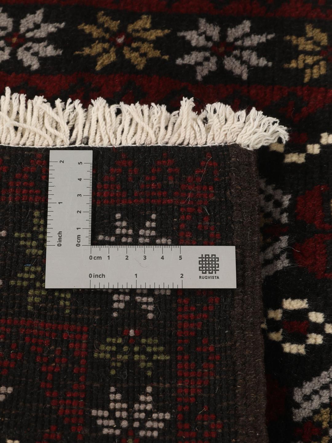 Handmade Middle Eastern Beluch rug with tribal motifs in multicolor