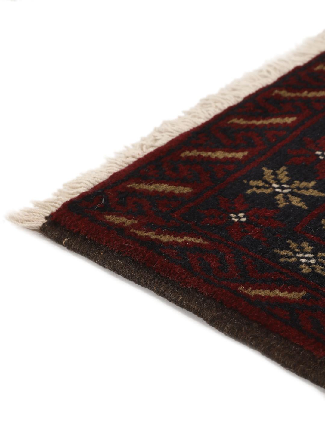 Hand-knotted Baluch rug with geometric patterns in dark red and dark blue tones