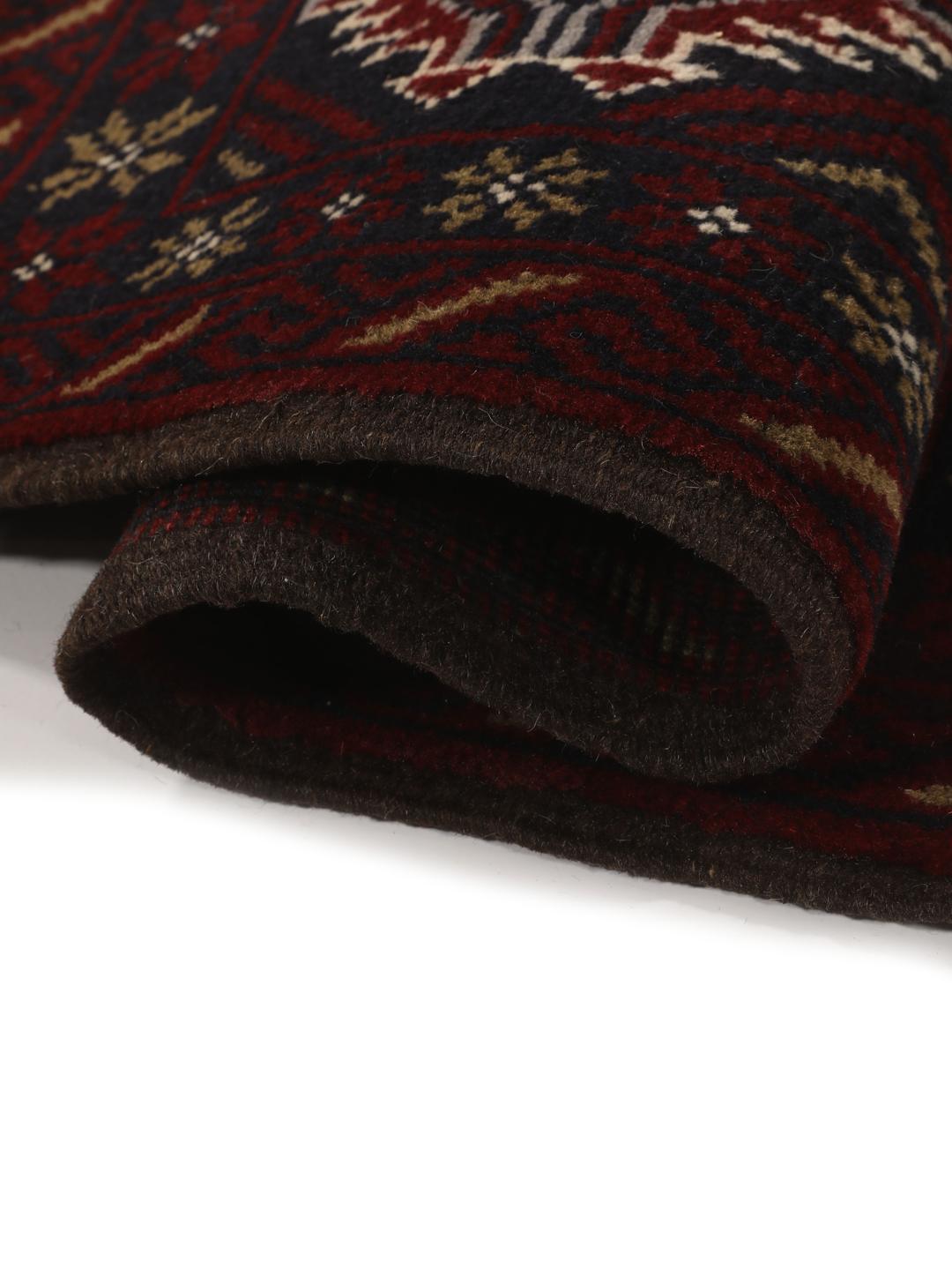 Hand-knotted Baluch rug with geometric patterns in dark red and dark blue tones