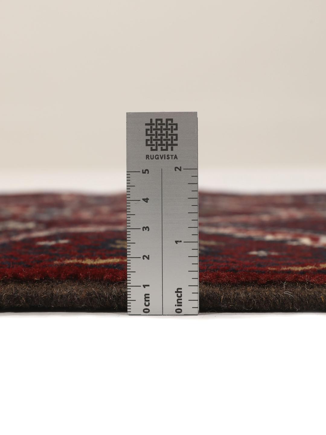 Hand-knotted Baluch rug with geometric patterns in dark red and dark blue tones