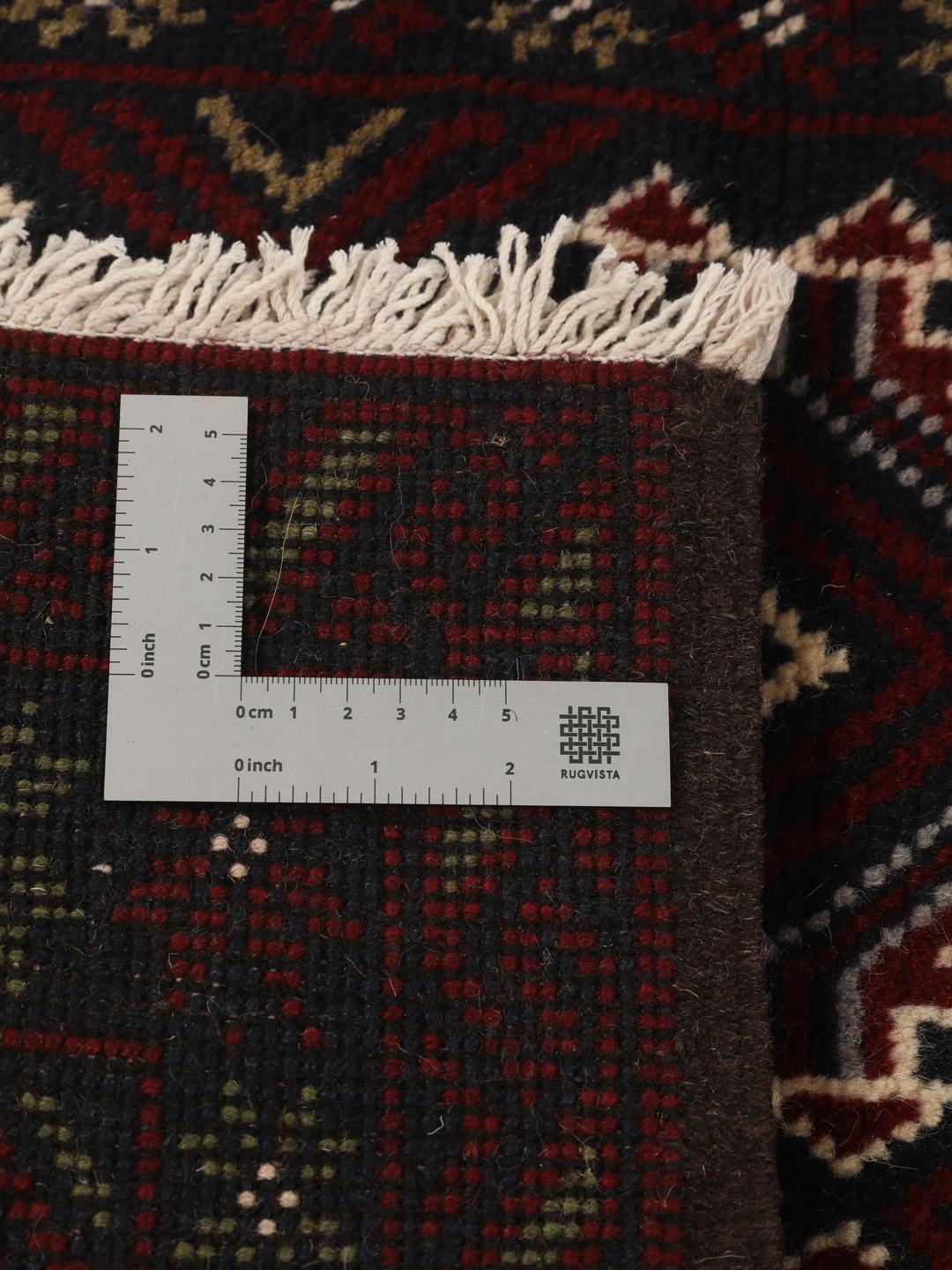 Hand-knotted Baluch rug with geometric patterns in dark red and dark blue tones