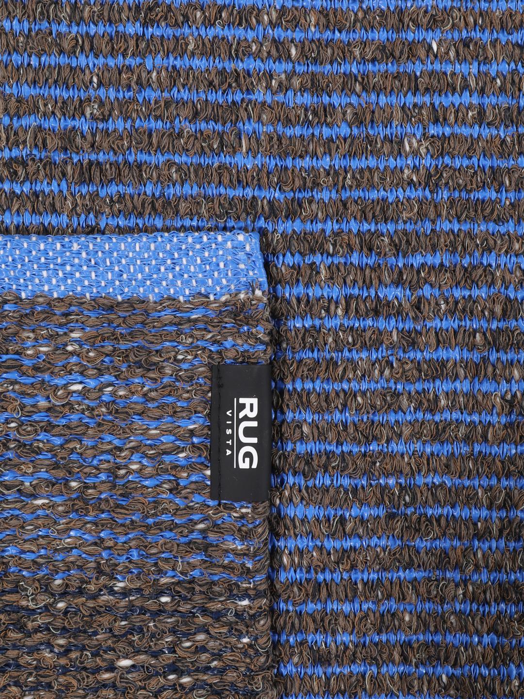 Een blauw en bruine loper met een gestreept en geometrisch patroon.