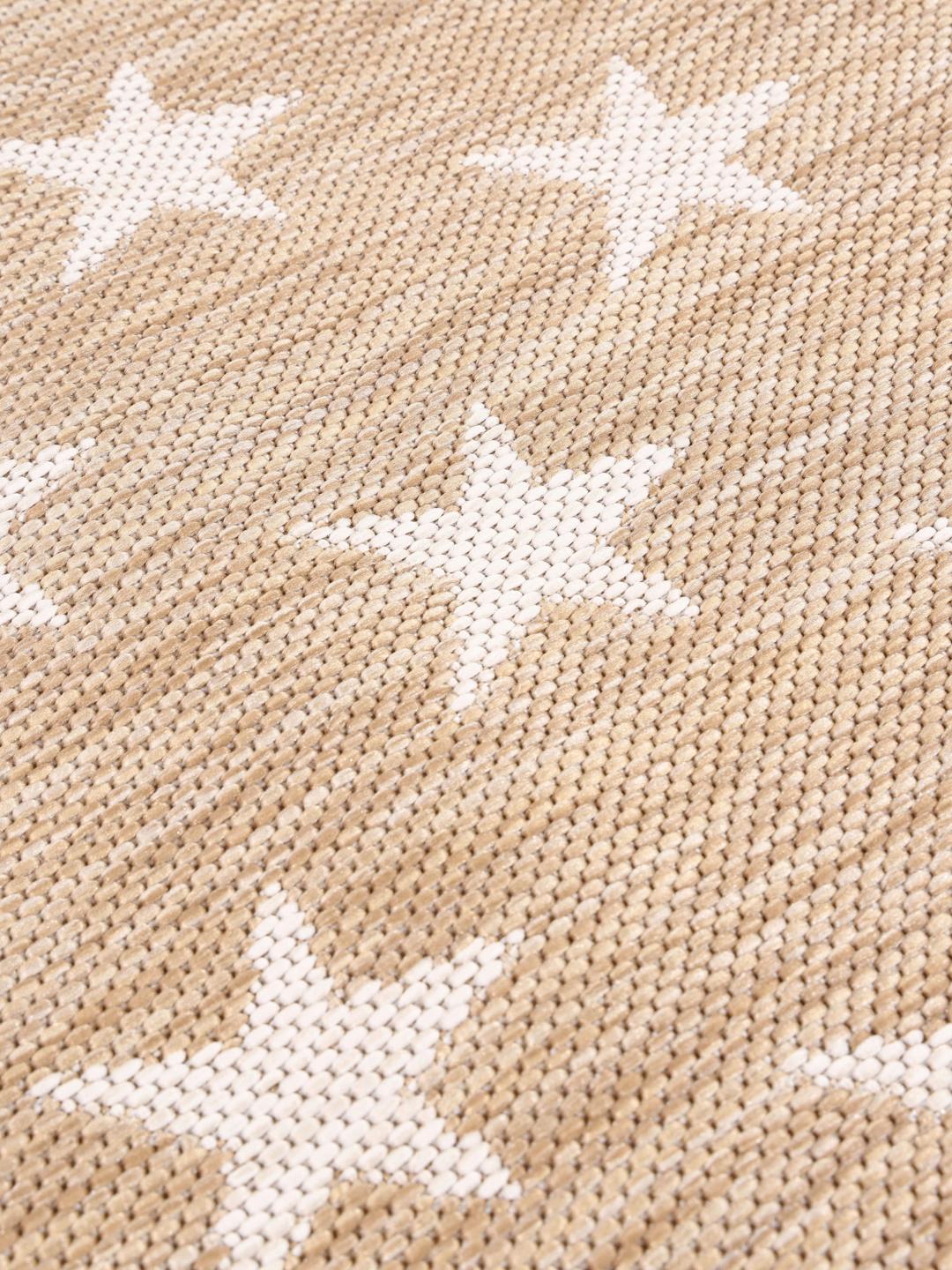 rundt beige tæppe med stjernemønster