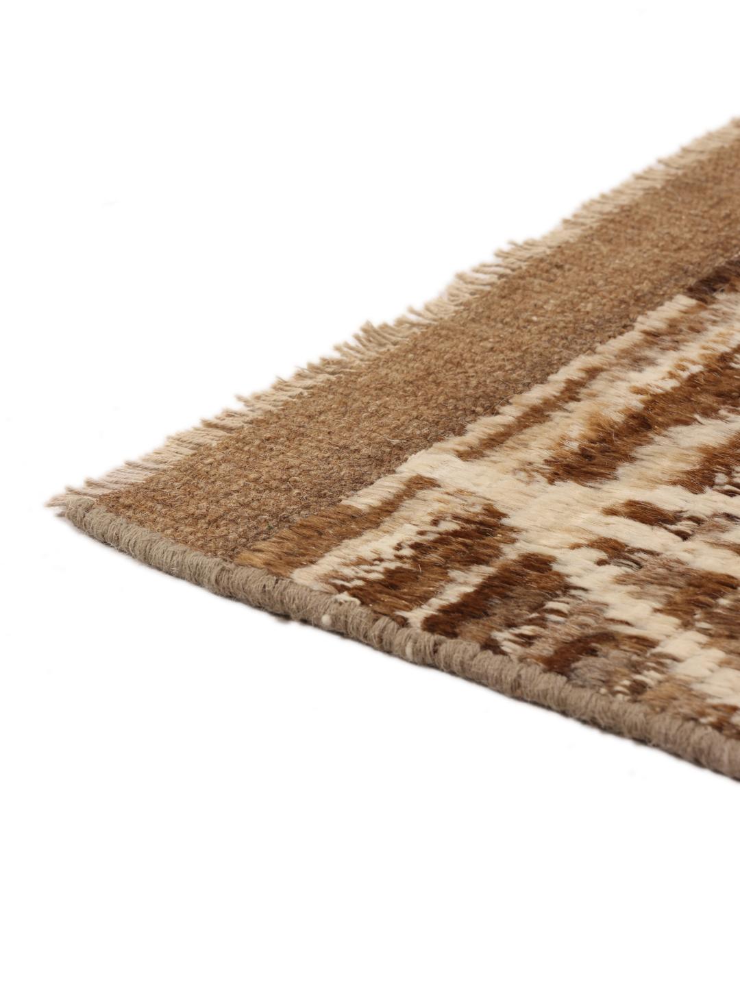 Hand-knotted rug from the Middle East with a geometric pattern in brown and beige tones.