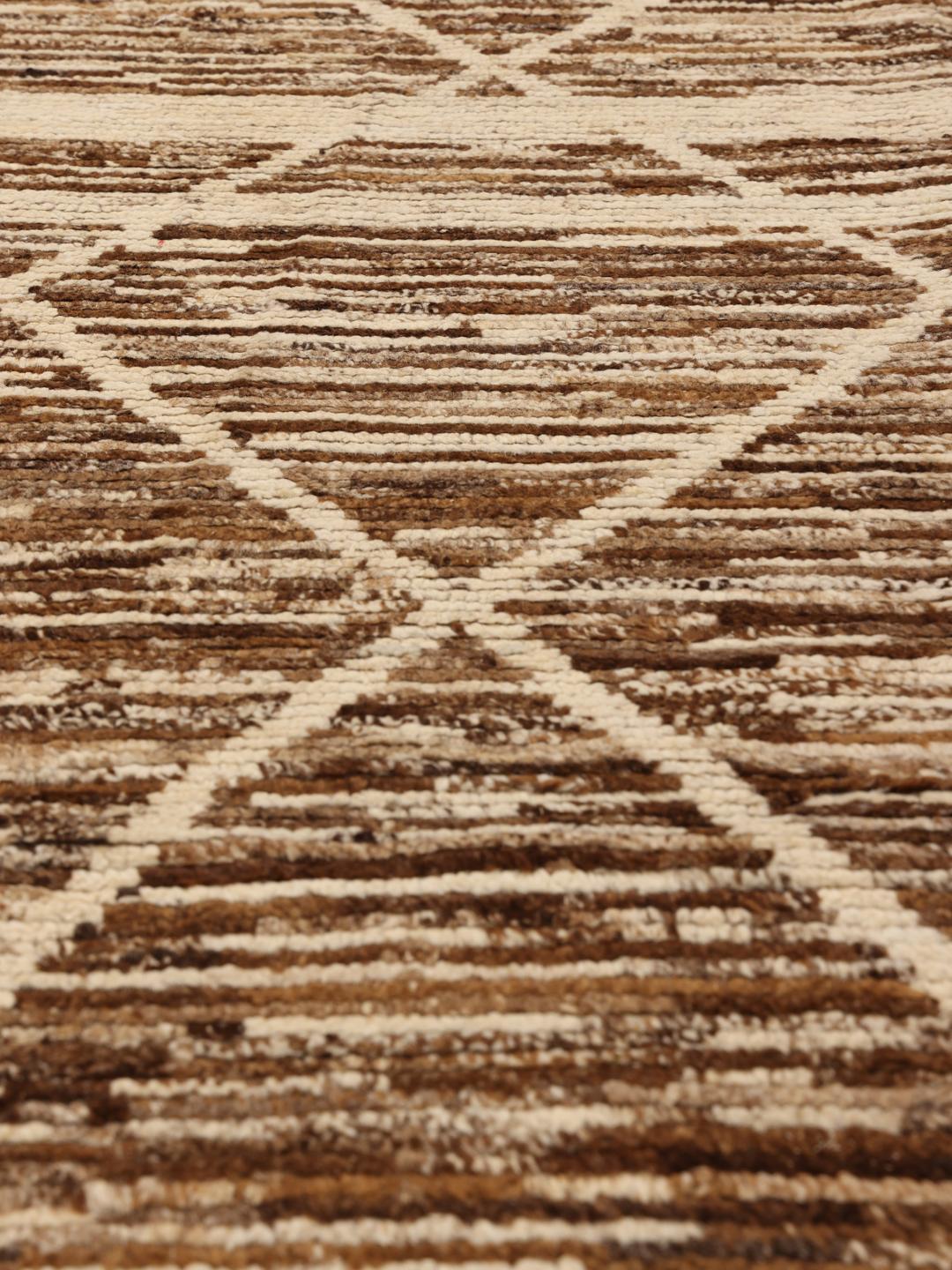 Hand-knotted rug from the Middle East with a geometric pattern in brown and beige tones.